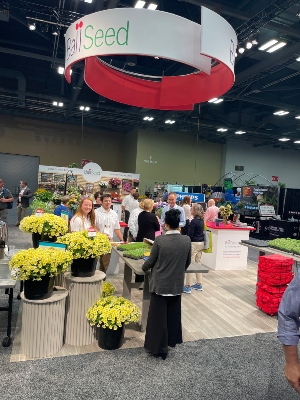 People at a tradeshow with flowers and plants
