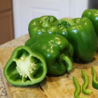 Block-shaped green peppers on a cutting board