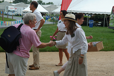 Two women shaking hands outdoors