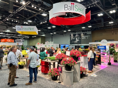 People at a tradeshow with flowers and plants