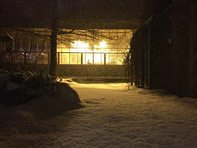 A greenhouse at night during the winter